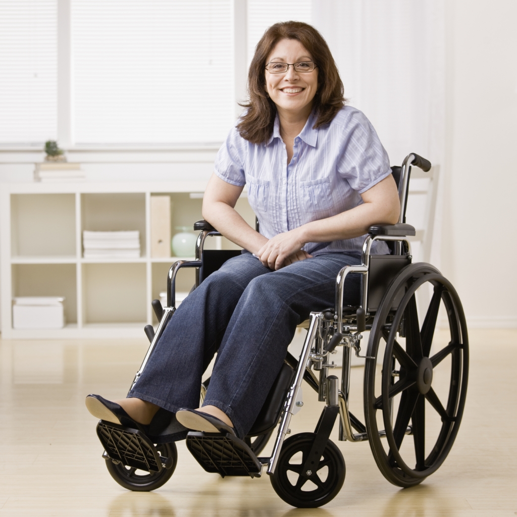 Photo of a smiling woman sitting in a wheelchair - Stellar Transportation